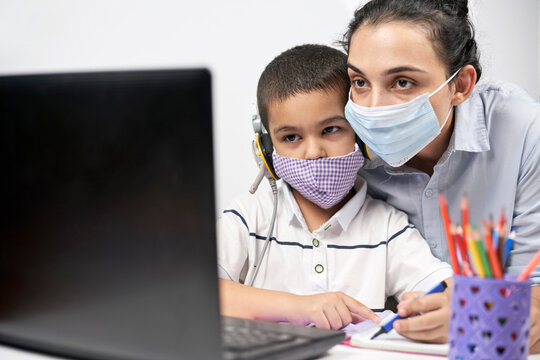 Young Mother Helping Son To Do Homework. Mom And Child Studying Online Via Laptop. Homeschooling During Covid 19 Quarantine Period