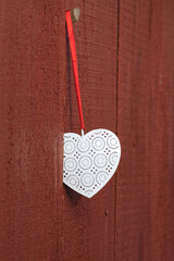 Metal heart on wooden background. Love symbol. 
