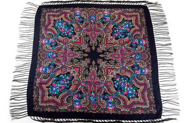 top view on flat lay black cotton scarf with fringe and bright paisley floral ornament