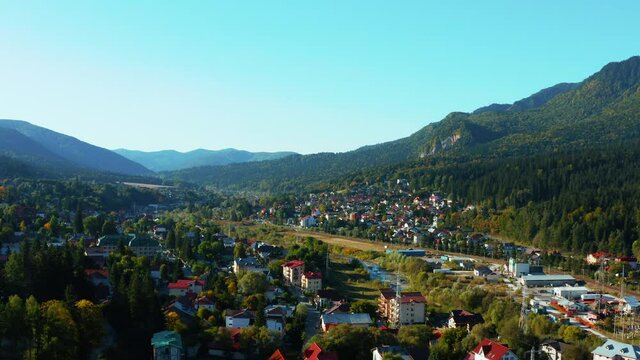 Aerial panoramic view of beautiful city Busteni of Carpathian Mountains. Majestic landscape in Romania, travel, 4k
