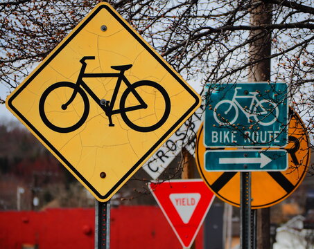 A group of Bicycle, yield and railroad crossing road signs