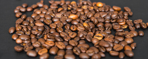 Coffee beans on a black table, poster or background