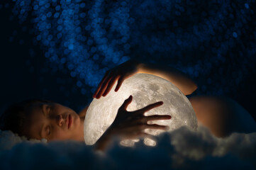 Female tenderness, a girl in an embrace with the moon against the background of stars, galaxies and...