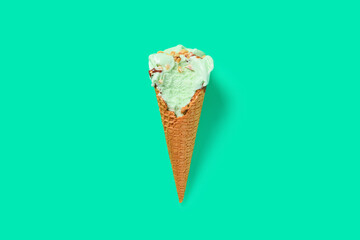 top view fresh hami melon and oats flavor ice cream cone with couple of bites on green background