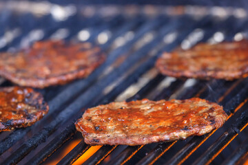 beef patties being grilled