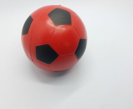 red and black soccer ball on white background
