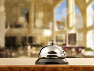 Vintage hotel reception service bell on the desk.