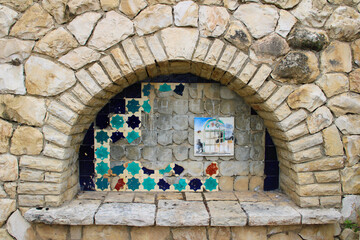 broken mosaic in stone wall
