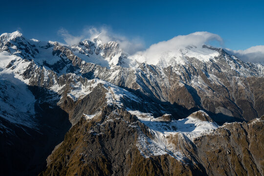 The view out the window of a scenic flight looking out to glaciers and mountains in the South Island of New Zealand