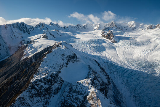 The view out the window of a scenic flight looking out to glaciers and mountains in the South Island of New Zealand