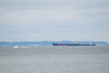 Gdansk, Poland, July 5, 2020. Ships at sea visible from a beach at Westerplatte in Gdansk.