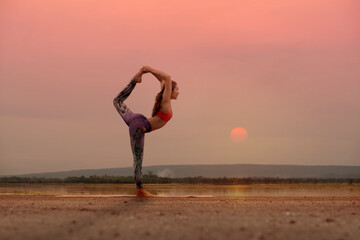 woman practice yoga with sun background