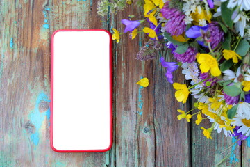 Phone on the table with a bouquet of flowers