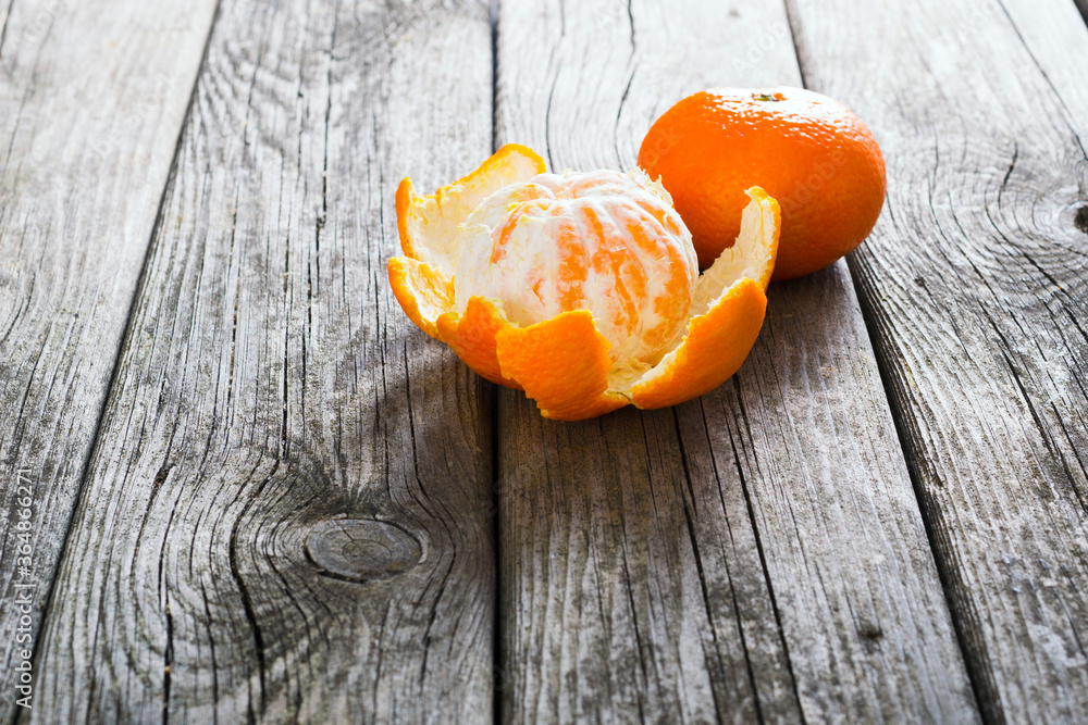 Poster peeled and whole tangerines on old wood table