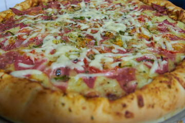 detail of ready to eat pizza, cheese, salami, pepper