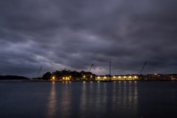 Obraz premium moody clouds over waterside warehouse