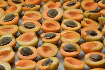 Apricots background. Apricot slices. Fresh organic fruits. Countryside garden harvest. Fruit salad, smoothie, pie and jam ingredient.