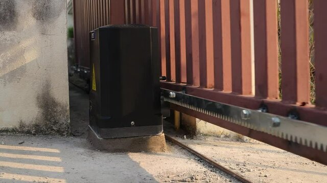 Technician installed  and test automatic gate motor system working for control gate home security system