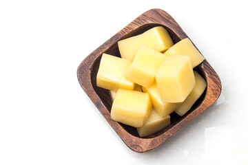 Close Up of Mozzarella Cheese Cubes in Wooden Bowl Isolated on White Background.