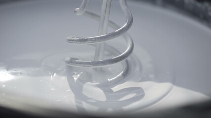 The process of mixing white paint by the drill in the bucket © stanis88