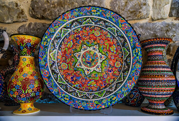 Obraz na płótnie Canvas Montenegrin hand painted decorative plates with a floral pattern in at a souvenir shop in Kotor old town in Montenegro