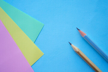 Pastel Color paper and pencil for background. minimalist back to school copy space concept for text.