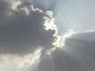 Fototapeta na wymiar Dark gray clouds with crepuscular sun rays or splintered light