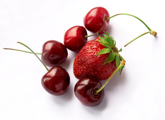 Fresh ripe berries photographed on a white background. Isolated. Strawberries and cherries.