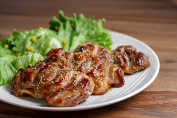 dish of teriyaki chicken with salad, corn and ssame seeds	