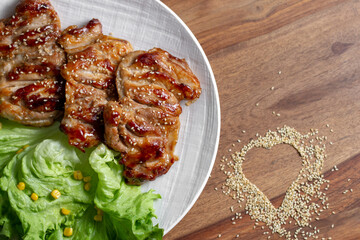 dish of teriyaki chicken with salad, corn and ssame seeds	