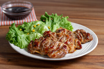 dish of teriyaki chicken with salad, corn and ssame seeds	