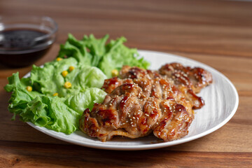 dish of teriyaki chicken with salad, corn and ssame seeds	