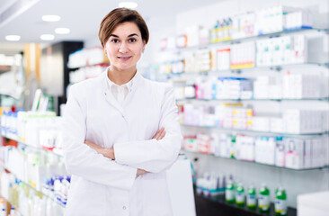 positive european female pharmacist demonstrating assortment of pharmacy