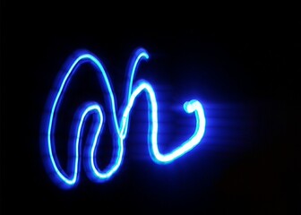 Light painting design. Combination of sky blue and white light against a black background 