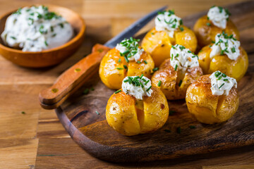 Oven baked potatoes with sour cream with butter and chives