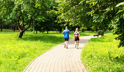 Two cyclists on a forest trail, a man and a woman riding on a sunny day