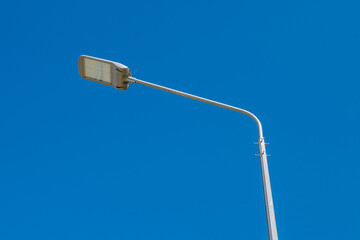 Street lamp against a clear blue sky. .A modern street LED lighting pole. Copy space.