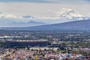 aerial view of azteca stadium and iconic snowed volcanoes in the back