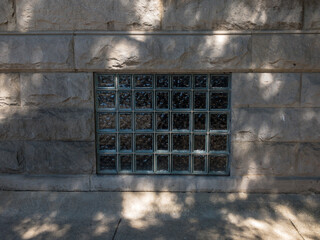 glass block window surrounded by stone and concrete