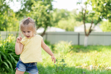 little girl laughing in the garden