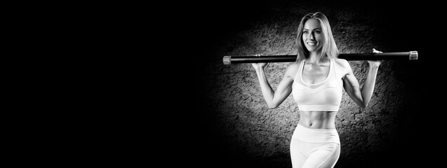 Charming girl posing with a bodybar. The concept of fitness, bodybuilding and healthy lifestyle.