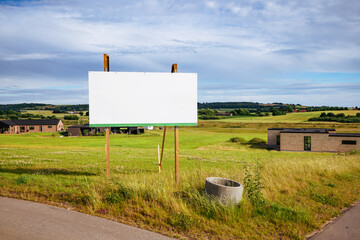 Large billboard sign on a green field - obrazy, fototapety, plakaty