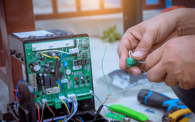 A Technician assembling motor  system and testing motor automatic gate home security system.Home...