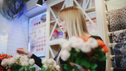 Woman florist makes flower bouquet