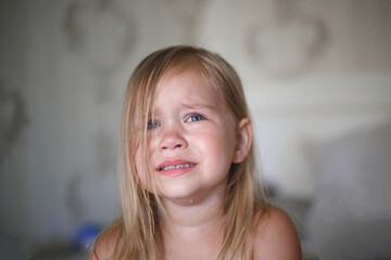 portrait of a beautiful little crying girl