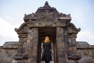 muslim tourist woman wearing headscarf or hijab at plaosan temple, Klaten, Central Java, Indonesia