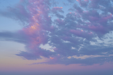 Naklejka na ściany i meble clouds floating in the blue sky at sunset