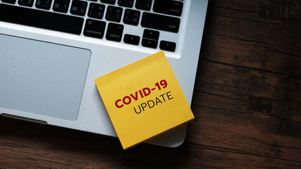 COVID-19 UPDATE text  on laptop keyboard. Covid-19 or Coronavirus Concept.