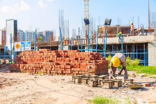 Karnal, Haryana, India - march 2018 : man making up of bricks near the big building in karnal