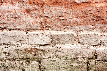 Texture of a brick wall with cracks and scratches which can be used as a background